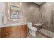 Modern bathroom featuring glass walk-in shower, stone floor, and vanity with marble counter and decorative mirror at 2466 Spruce Meadows Dr, Broomfield, CO 80023