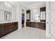 Spacious bathroom with dual vanities, elegant cabinetry, modern fixtures, and walk-in closet access at 2466 Spruce Meadows Dr, Broomfield, CO 80023