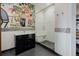 Modern bathroom features bright colorful mural, large glass shower, and sleek black vanity with decorative mirror at 2466 Spruce Meadows Dr, Broomfield, CO 80023