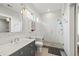 Bright bathroom with modern fixtures, glass-enclosed shower, a gray vanity, and a stylish mirror at 2466 Spruce Meadows Dr, Broomfield, CO 80023