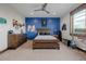 Bedroom featuring wooden bed frame, light colored carpet, and a large window with natural light at 2466 Spruce Meadows Dr, Broomfield, CO 80023