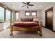 Comfortable bedroom with wood frame bed, ceiling fan, and great natural light from three windows at 2466 Spruce Meadows Dr, Broomfield, CO 80023