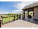 Beautiful outdoor deck with seating area, stone pillars and views of lush green spaces at 2466 Spruce Meadows Dr, Broomfield, CO 80023