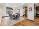 Elegant dining room with wooden floors, stylish chairs, decorative chandelier, and large window at 2466 Spruce Meadows Dr, Broomfield, CO 80023