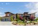 Stunning custom home with stone accents, modern design, lush landscaping, and a three-car garage at 2466 Spruce Meadows Dr, Broomfield, CO 80023