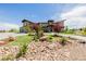 Beautiful home showcasing a landscaped front yard with decorative rock and lush greenery, offering great curb appeal at 2466 Spruce Meadows Dr, Broomfield, CO 80023