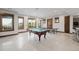 Entertaining game room featuring a pool table, ping pong, and large windows at 2466 Spruce Meadows Dr, Broomfield, CO 80023
