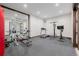 Well-equipped home gym with weightlifting equipment, treadmill, and mirrored wall at 2466 Spruce Meadows Dr, Broomfield, CO 80023