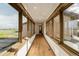 Bright hallway featuring hardwood floors, a row of windows, and natural light at 2466 Spruce Meadows Dr, Broomfield, CO 80023