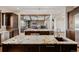 Spacious kitchen with granite countertops, dark wood cabinets, and an open design to the living area at 2466 Spruce Meadows Dr, Broomfield, CO 80023
