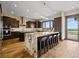 Modern kitchen featuring a large island with seating, stainless steel appliances, and wooden cabinetry at 2466 Spruce Meadows Dr, Broomfield, CO 80023