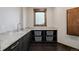 Functional laundry room with granite countertops, storage baskets, and sink at 2466 Spruce Meadows Dr, Broomfield, CO 80023