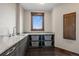 Functional laundry room with granite countertop, ample storage shelves, sink, and natural light at 2466 Spruce Meadows Dr, Broomfield, CO 80023