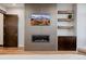 Stylish living room with modern fireplace, built-in shelves, and hardwood floors at 2466 Spruce Meadows Dr, Broomfield, CO 80023