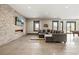 Spacious living room with a stone accent wall, modern fireplace, and large windows for natural light at 2466 Spruce Meadows Dr, Broomfield, CO 80023