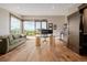 Spacious home office with a large window, glass desk, comfortable couch, and a dark wood door at 2466 Spruce Meadows Dr, Broomfield, CO 80023