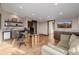 Bright office features large glass desk, hardwood floors, and a comfortable couch at 2466 Spruce Meadows Dr, Broomfield, CO 80023