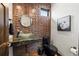 Stylish powder room featuring textured wooden wall accents, vessel sink, and modern fixtures at 2466 Spruce Meadows Dr, Broomfield, CO 80023