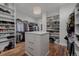 Organized walk-in closet with shelving, hanging racks, and central storage island at 2466 Spruce Meadows Dr, Broomfield, CO 80023