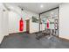 Home gym with a punching bag, weight rack, rubber flooring, and wood trim at 2466 Spruce Meadows Dr, Broomfield, CO 80023