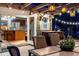 Outdoor deck with pergola, lighting, seating, and a glimpse into the adjacent kitchen at 601 E 131St Ct, Thornton, CO 80241