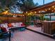 Charming covered backyard patio area featuring wood floors, comfortable seating, and bistro lighting at 601 E 131St Ct, Thornton, CO 80241