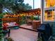 Backyard deck featuring a pergola with string lights, dining table, seating and grill at 601 E 131St Ct, Thornton, CO 80241