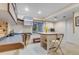 Bright basement with built-in shelves, a desk, and a table offers versatile space at 601 E 131St Ct, Thornton, CO 80241