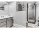 Clean bathroom with stylish gray vanity, modern shower, and wood-look flooring at 601 E 131St Ct, Thornton, CO 80241