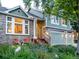 Attractive home featuring a three-car garage, a welcoming front porch, and lush landscaping at 601 E 131St Ct, Thornton, CO 80241