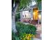 Inviting home featuring a colorful front garden, a quaint seating area, and a charming brick facade at 601 E 131St Ct, Thornton, CO 80241