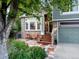 Delightful home featuring a lush garden, a charming front porch with seating, and a well-maintained yard at 601 E 131St Ct, Thornton, CO 80241
