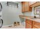 Practical laundry room with sink, cabinets, and counter space at 601 E 131St Ct, Thornton, CO 80241