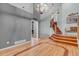Open-concept living area with hardwood floors, staircase, and a fireplace view from an adjoining room at 601 E 131St Ct, Thornton, CO 80241