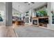 Open-concept living room with fireplace and large windows overlooking backyard at 601 E 131St Ct, Thornton, CO 80241