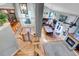 Open-concept living room with hardwood floors, fireplace, vaulted ceilings, and access to the kitchen and outdoor space at 601 E 131St Ct, Thornton, CO 80241