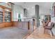 Spacious living area with tall ceilings, a built-in bookshelf, and hardwood floors with natural light at 601 E 131St Ct, Thornton, CO 80241
