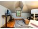 Attic space with wooden floors, a desk with a monitor, and storage at 3935 Pierson St, Wheat Ridge, CO 80033
