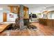 Spacious finished basement with a bar, stone decor, tile floors, and a staircase at 3935 Pierson St, Wheat Ridge, CO 80033