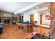 Spacious finished basement featuring a pool table, foosball, fireplace, and custom mural for entertainment at 3935 Pierson St, Wheat Ridge, CO 80033