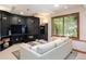 Cozy finished basement with black built-in shelves, television, and a neutral couch at 3935 Pierson St, Wheat Ridge, CO 80033