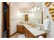 Bathroom vanity with double sinks, decorative lighting, mirrors, and gold hardware at 3935 Pierson St, Wheat Ridge, CO 80033