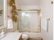 Bathroom featuring a shower with glass doors and gold hardware, vanity, and neutral decor at 3935 Pierson St, Wheat Ridge, CO 80033