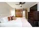 Comfortable bedroom featuring a ceiling fan, closet, television, and an inviting, tufted headboard at 3935 Pierson St, Wheat Ridge, CO 80033