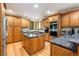 Open kitchen features granite countertops, a center island, and stainless steel appliances at 3935 Pierson St, Wheat Ridge, CO 80033