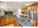 Kitchen featuring a center island with a cooktop and granite counters and opens to the living room at 3935 Pierson St, Wheat Ridge, CO 80033
