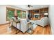 Living room features wood-burning fireplace, hardwood floors, custom built-ins, and an abundance of natural light at 3935 Pierson St, Wheat Ridge, CO 80033