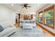 Bright and open living room with hardwood floors, stairs, and views of the kitchen at 3935 Pierson St, Wheat Ridge, CO 80033