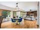 Open living and dining area with a hardwood floor and sliding glass doors to an outside deck at 3935 Pierson St, Wheat Ridge, CO 80033