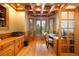 A handsome office features wood paneled walls, a wood paneled ceiling, and large bay windows at 3935 Pierson St, Wheat Ridge, CO 80033